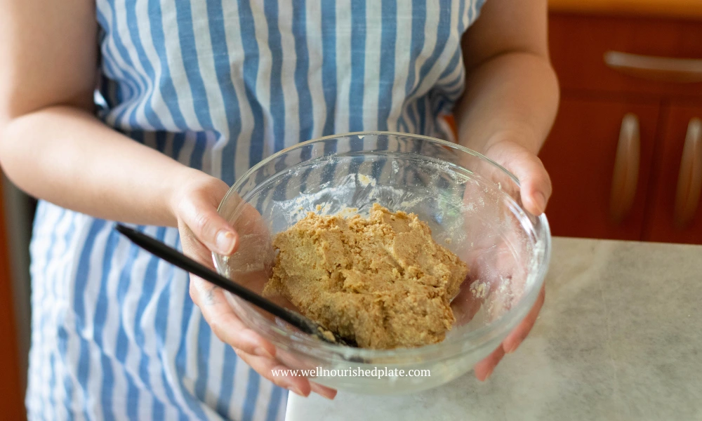 woman holding a bowl with the peanut butter oat bars base
