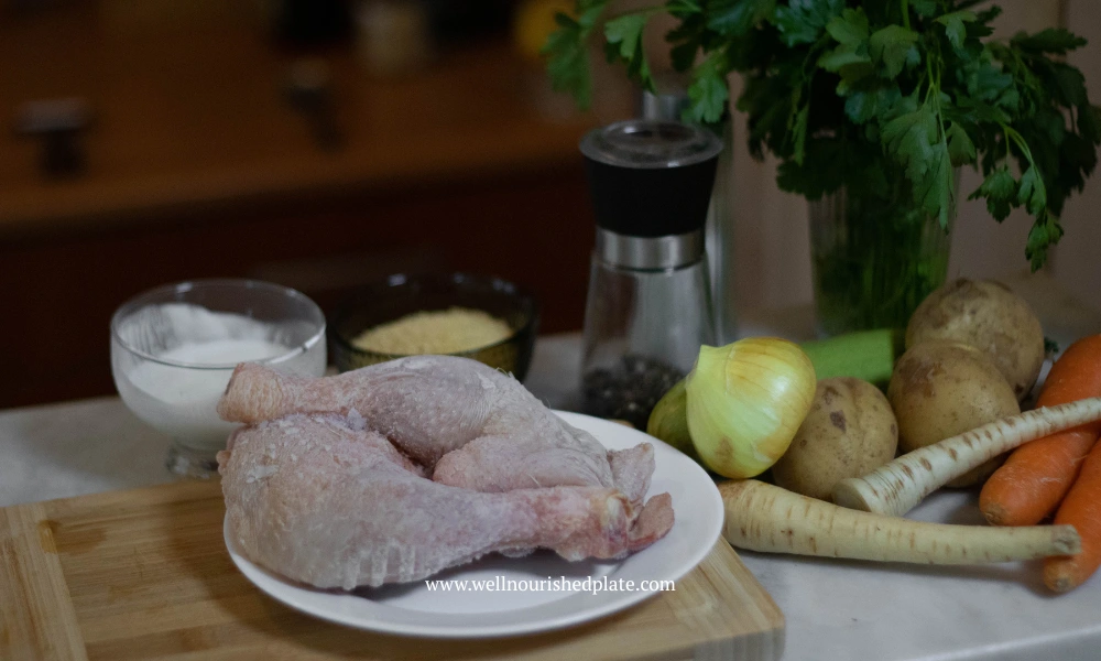 chicken and vegetables on a table, ingredients for a delicious soup