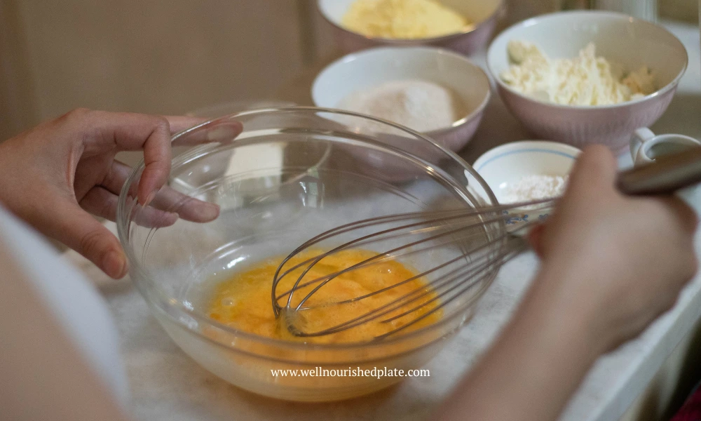whisking the eggs to make gluten free cornmeal muffins