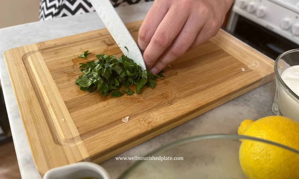 women chopping herbs for a delicious, creamy cucumber salad