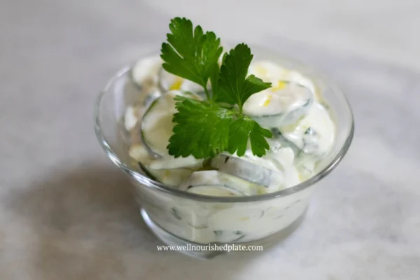 refreshing cucumber salad in a bowl with parsley