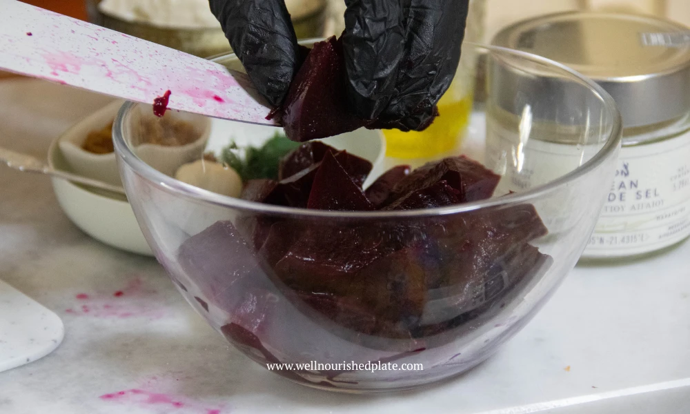 adding cooked beetroot to a salad bowl
