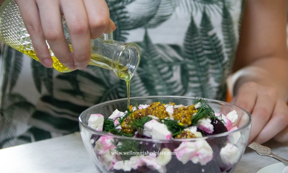 seasoning the beet salad with olive oil