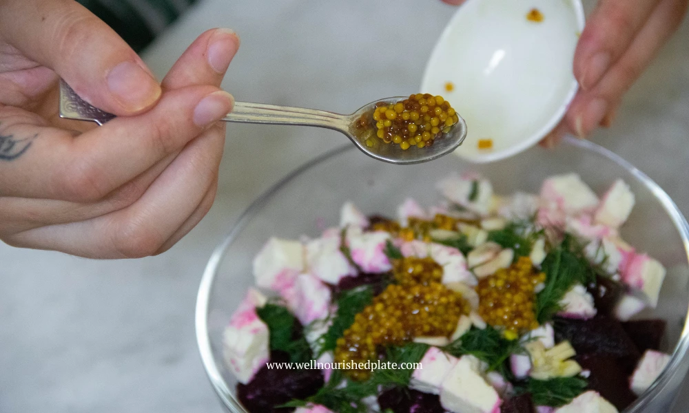 adding whole grain mustard to beet salad