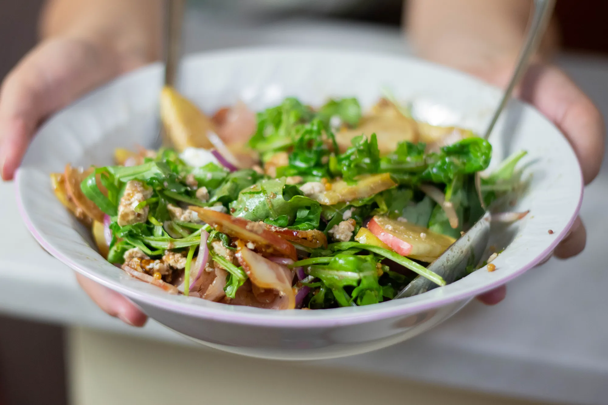 apple salad with arugula in a bowl
