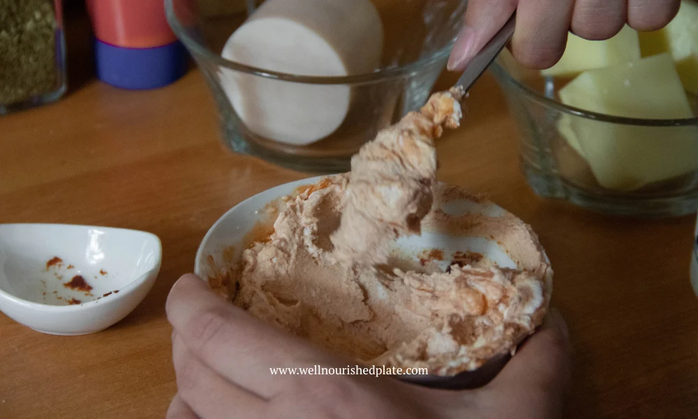 mixing cream cheese with ketchup for pizza base