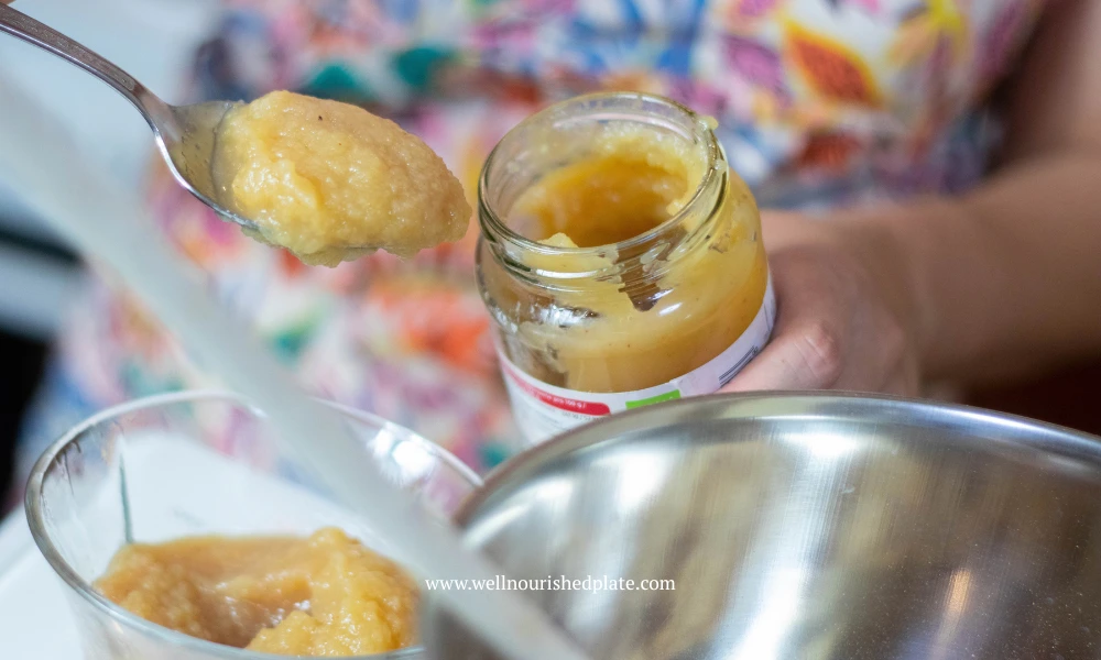 adding apple puree to a pot